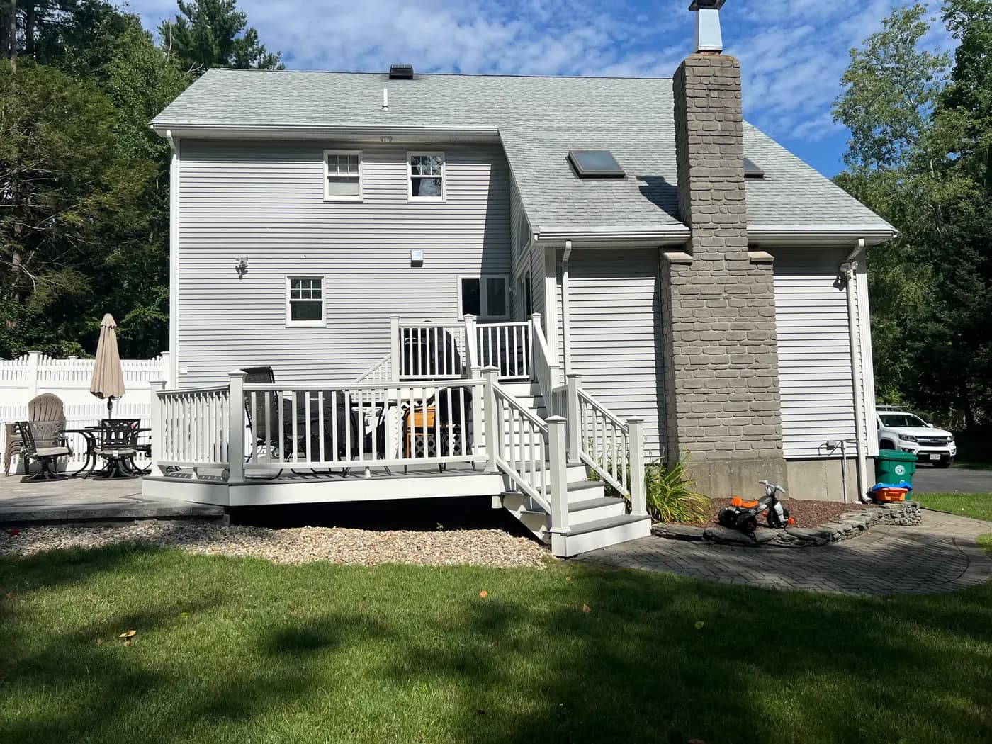 White composite deck with railings on a Massachusetts home