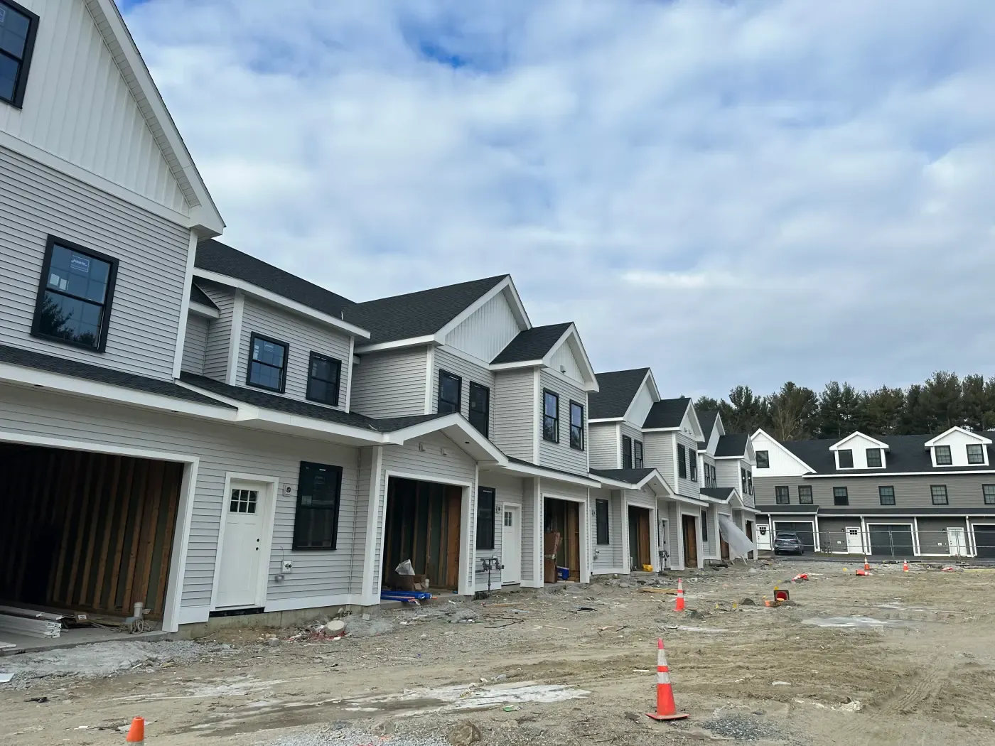 Row of new construction townhomes with mixed siding by FBS Construction